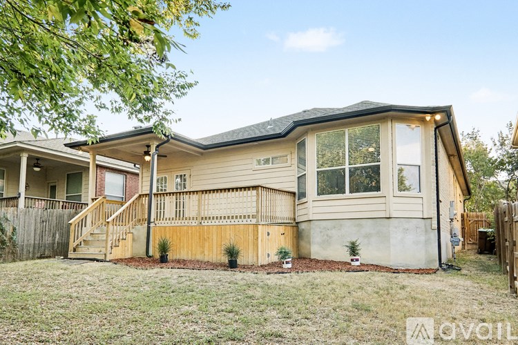 A house with a front yard and a fence.