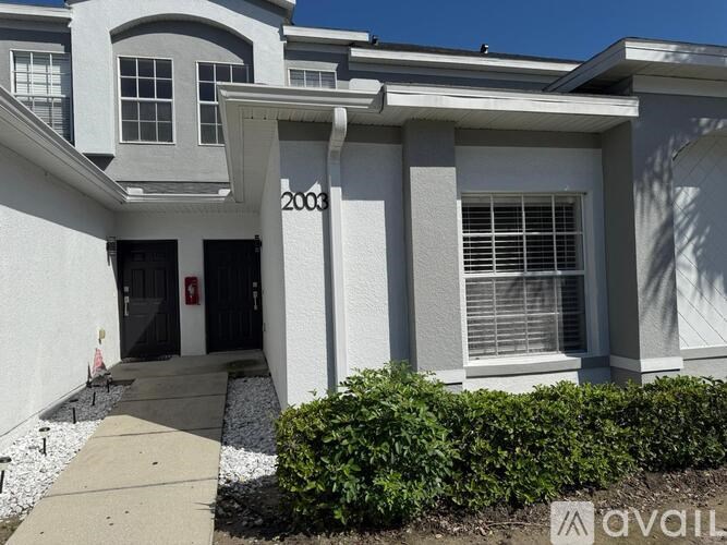 A white house with a black door and windows.