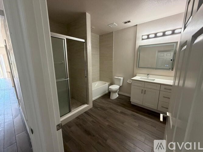 A bathroom with a toilet, sink, and shower.