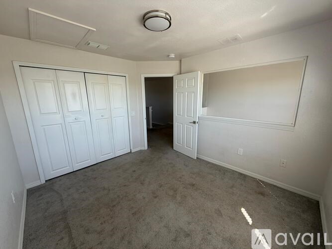 A room with white walls and a carpeted floor.