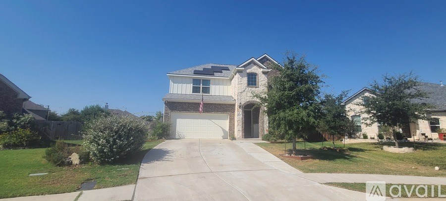 A house with a driveway and garage is for sale.