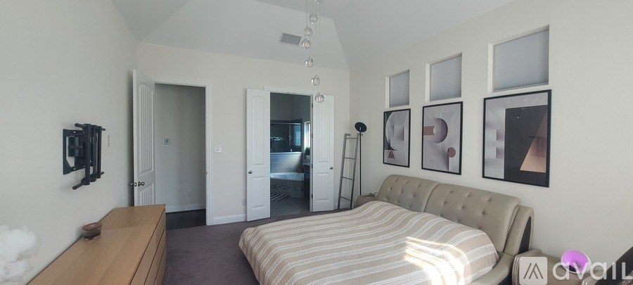 A bedroom with a bed, a dresser, and a mirror.