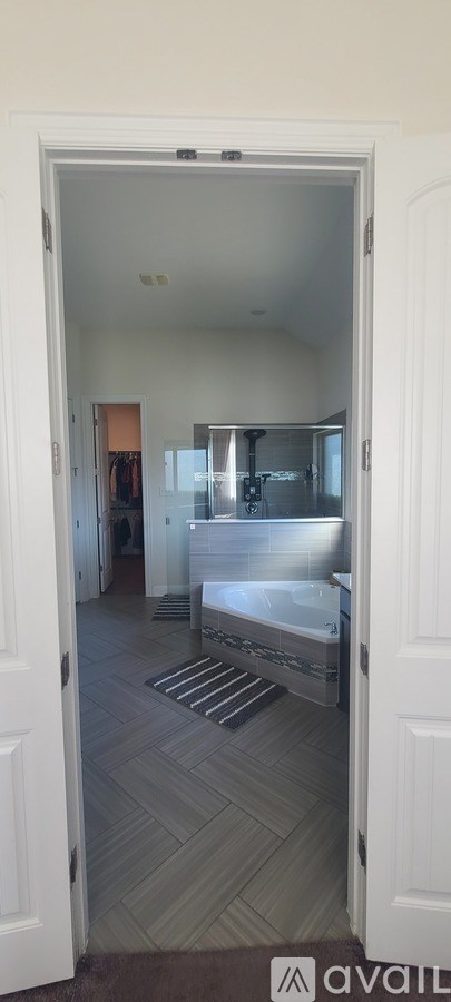 A bedroom with a bed and a mirror.