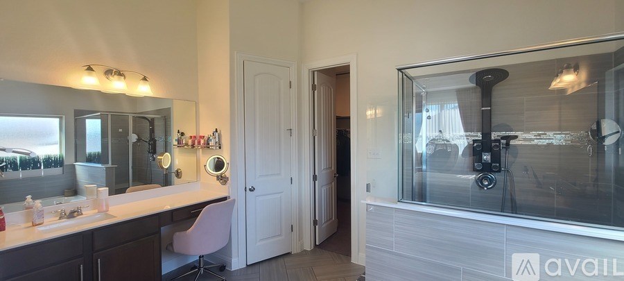 A bathroom with a vanity and a large mirror.