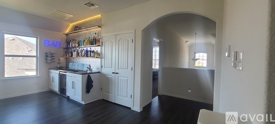 A kitchen with a bar area and a large window.