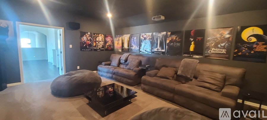 A living room with a grey couch and a bean bag chair.