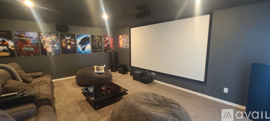 A home theater with a large screen and comfortable seating.