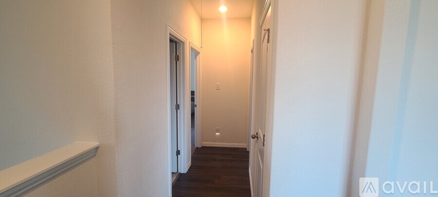 A long hallway with doors on either side.