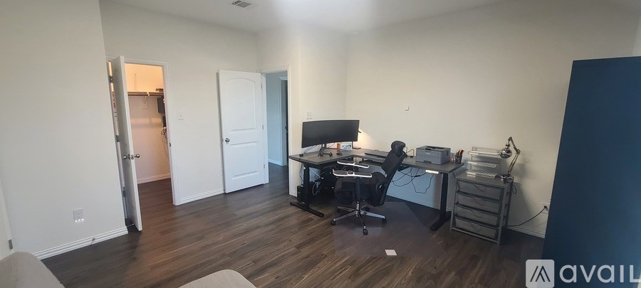 A room with a desk and a computer.