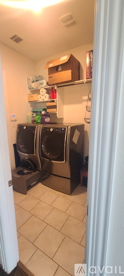A small laundry room with a washer and dryer.