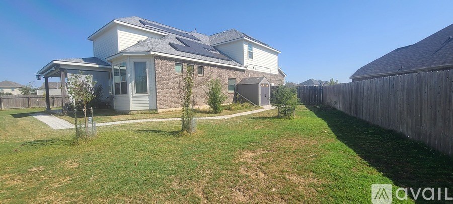 A house with a yard and a fence.