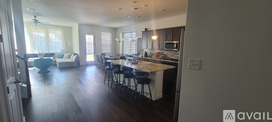 A kitchen with a bar and stools is available for rent.