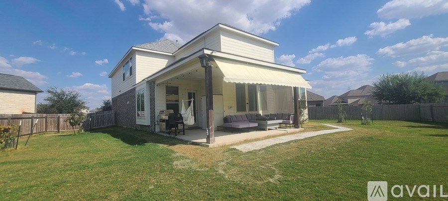 A house with a patio and a lawn in front.