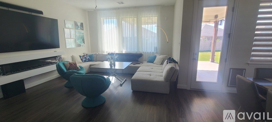 A living room with a white couch and a television.