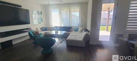 A living room with a white couch and a television.