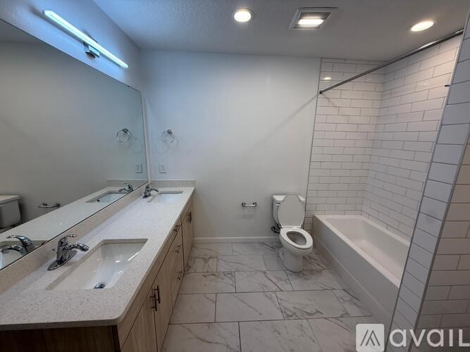 A bathroom with a toilet, sink, and bathtub.