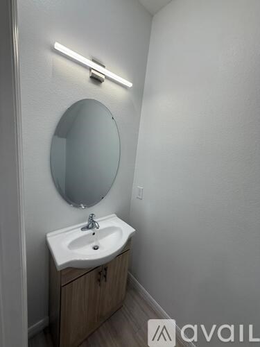 A bathroom with a sink and mirror.