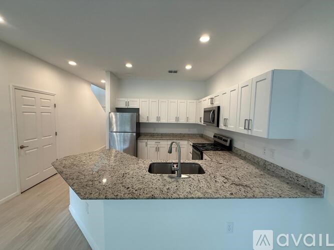 A kitchen with granite countertops and stainless steel appliances.