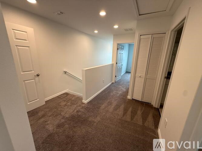 A room with a carpeted floor and white walls.