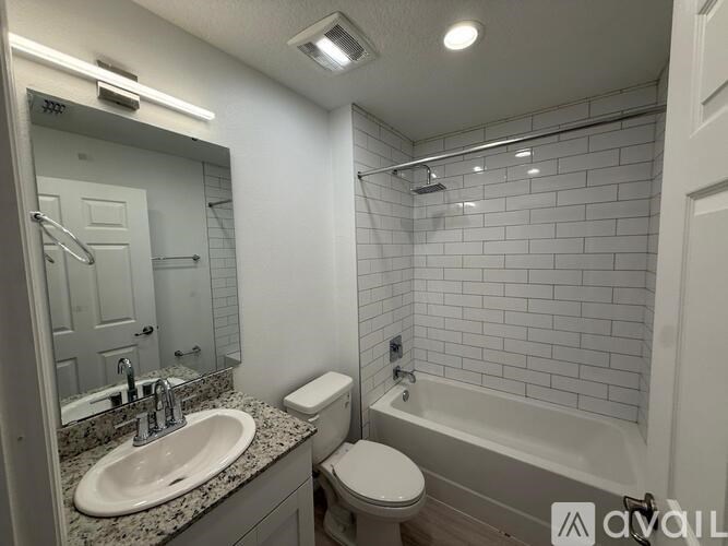 A bathroom with a sink, toilet, and bathtub.
