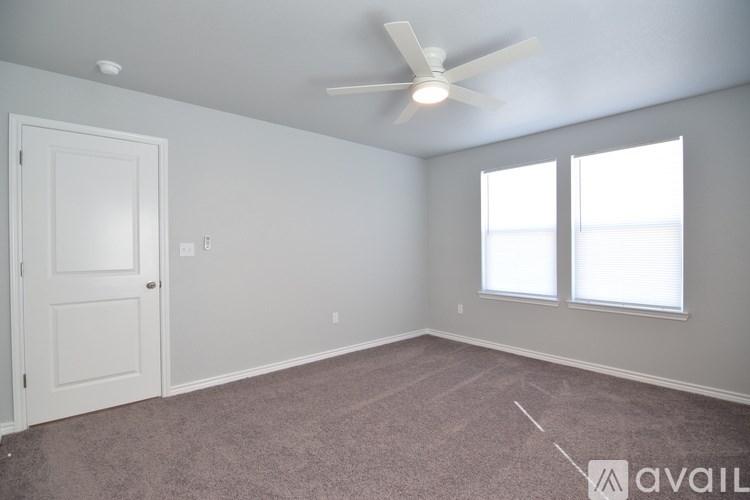 A white shelving unit in a room with a carpeted floor.