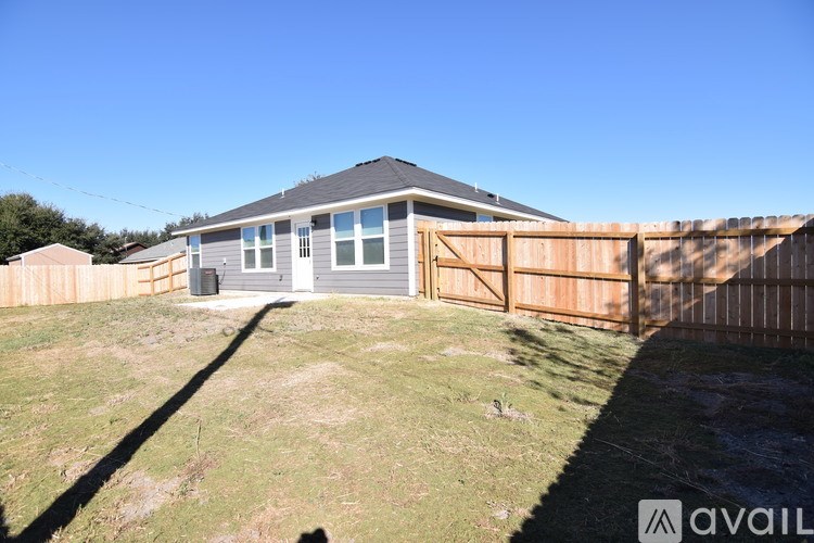 A house with a grey roof and a wooden fence.