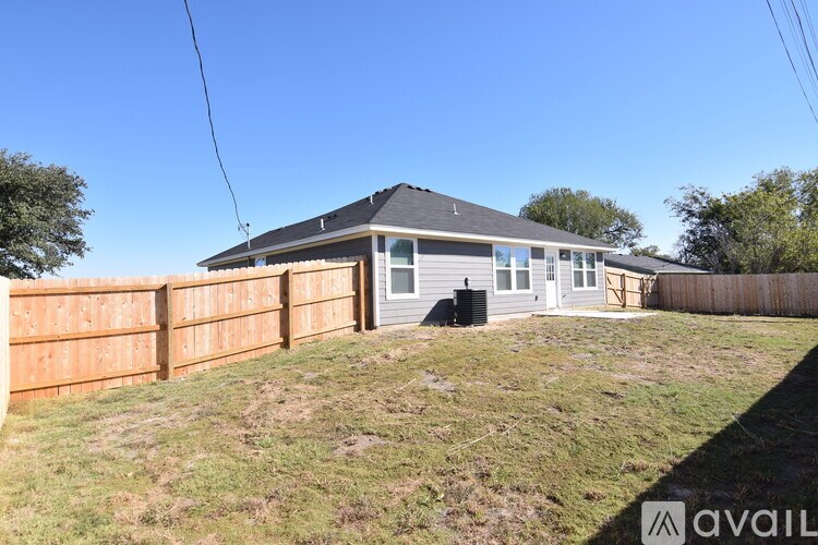 A house with a grey roof and a brown fence.