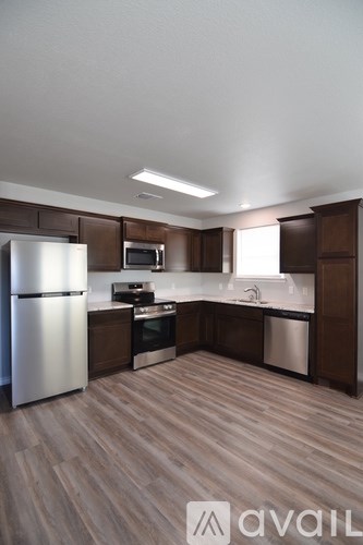 A room with a carpeted floor and a window with blinds.