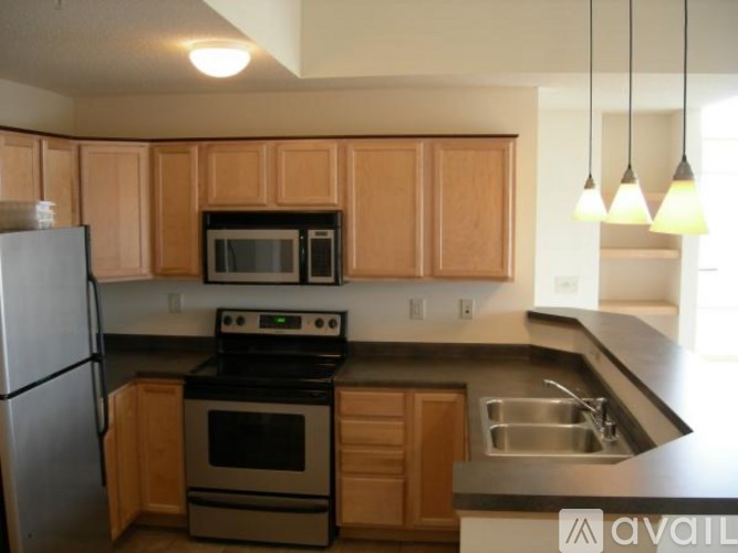 A kitchen with wooden cabinets and a black stove top oven.