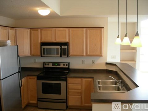A kitchen with wooden cabinets and a black stove top oven.