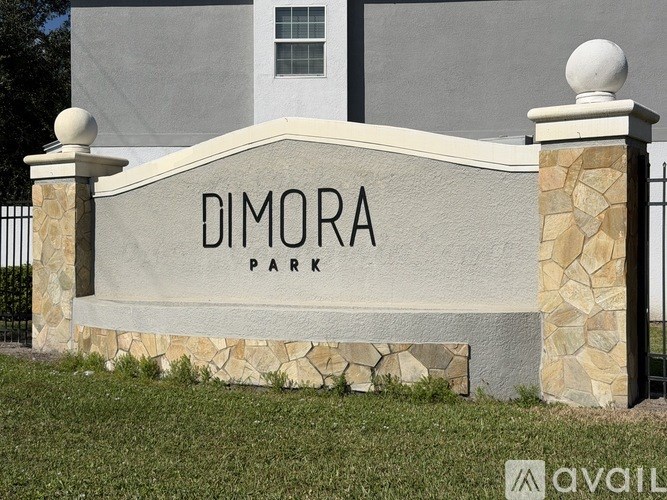 A sign that says Dimora Park in front of a building.