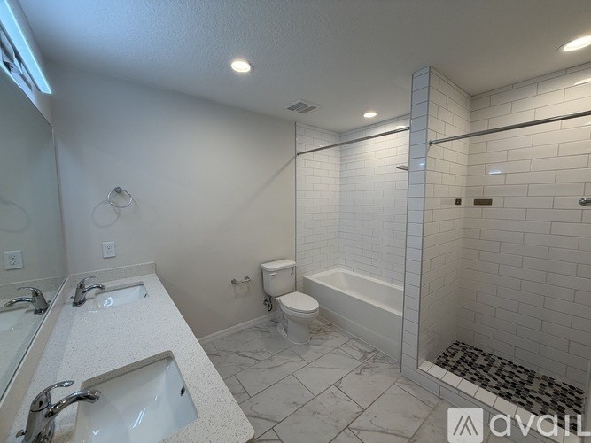 A bathroom with a toilet, sink, and shower.