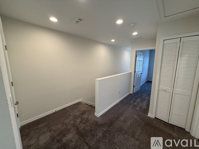 A room with a carpeted floor and white walls.