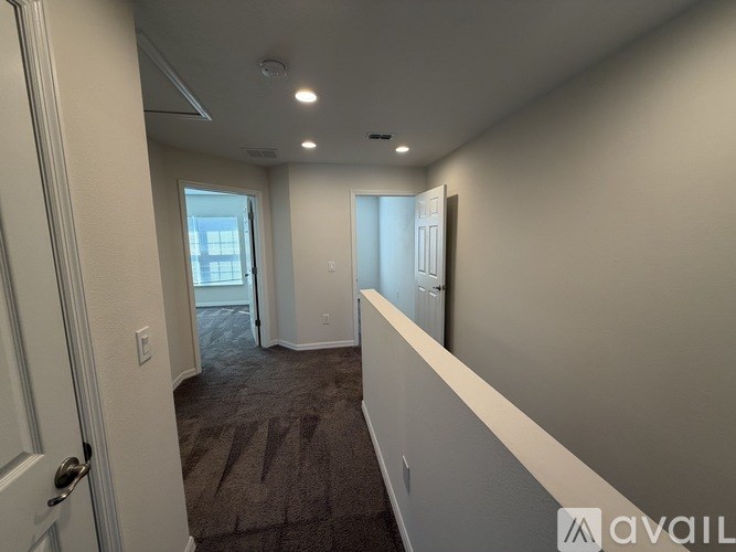 A room with a carpeted floor and a door leading to a balcony.