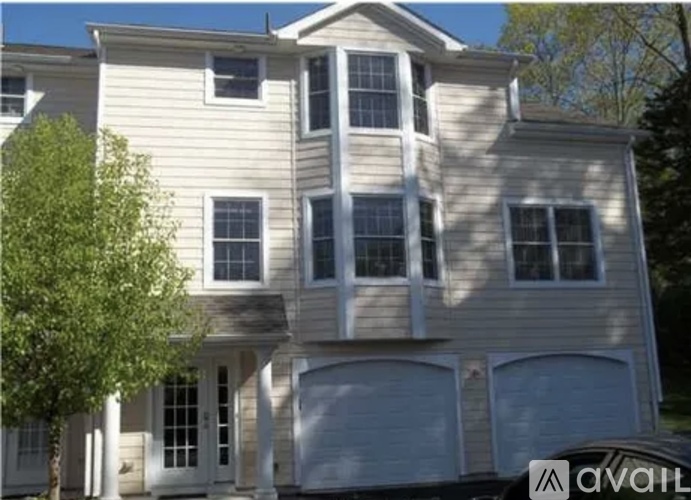 A two-story house with a garage is for sale.