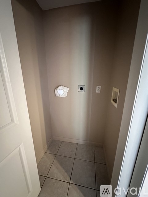 A small white light is mounted on a wall in a small room.