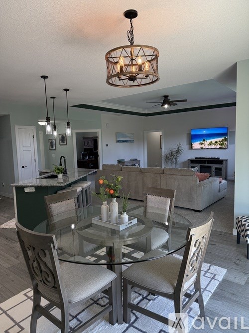 A modern dining room with a glass table and chairs.
