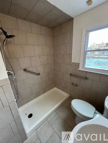 A bathroom with a tub, toilet and sink.