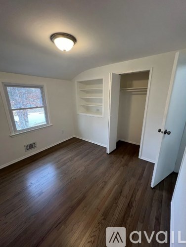 A room with wooden floors and a window.
