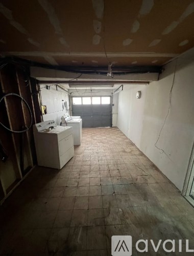 A room with a tiled floor and a window is available for rent.