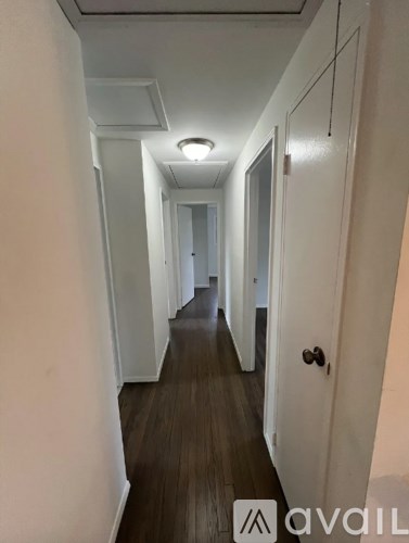 A long hallway with a door on the right.