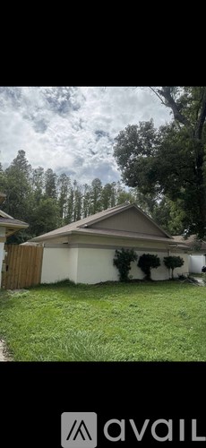 A house with a brown fence and a white wall.