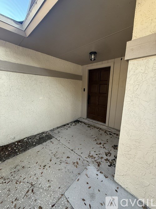 A room with a brown door and a skylight.