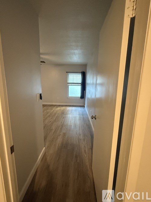 A long hallway with a door at the end.