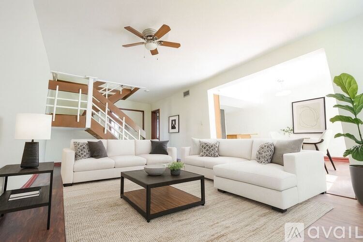 A living room with a white couch and a coffee table.