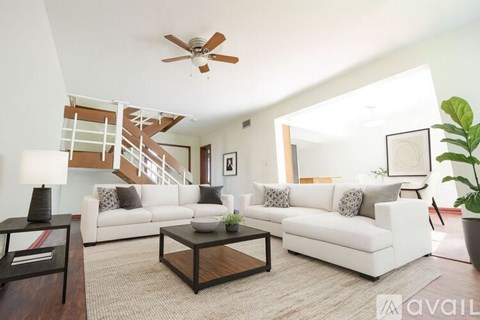 A living room with a white couch and a coffee table.