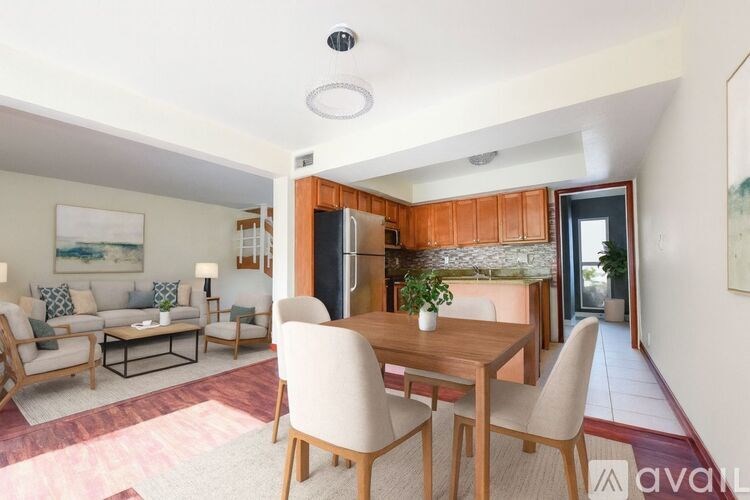 A modern kitchen with wooden cabinets and a dining table with chairs.