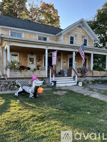 A house with a porch and a flag on it.