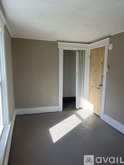 A room with a door and a window.