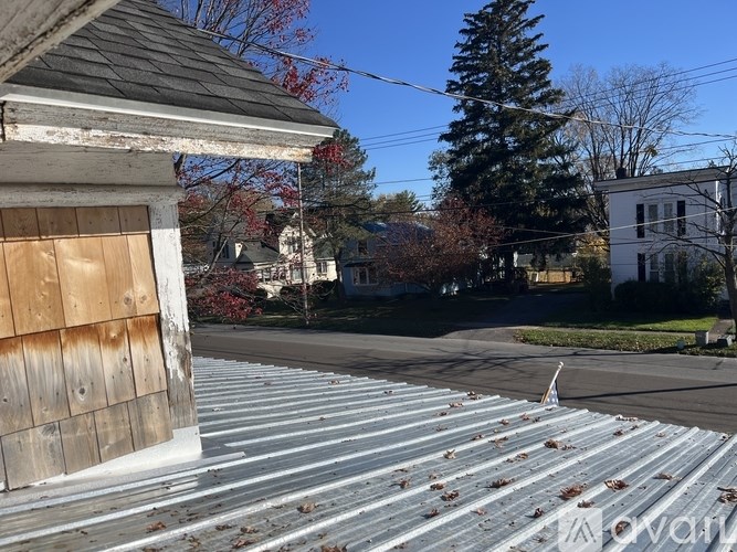 A metal roof with a wooden board on it.
